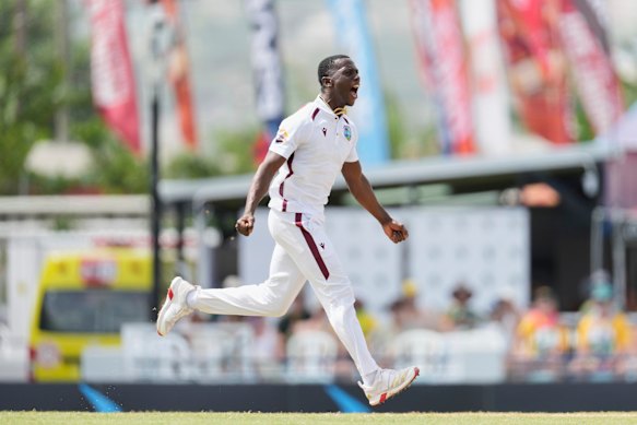 The West Indies' Shamar Joseph Coupon celebrates bea webster webet to Australia during the day. 