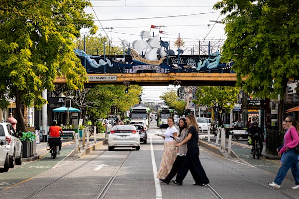 The train bridge north of Balaclava station as it crosses Carlisle Street, featuring the Lady of St Kilda art work.