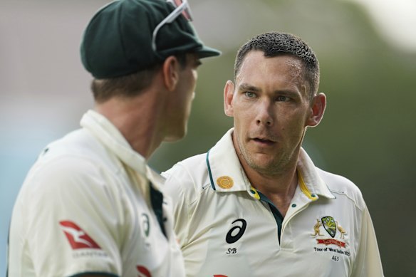 Australia’s Scott Boland, right, talks to captain Pat Cummins.