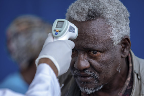 A man at the Zewditu Memorial Hospital in the Ethiopian capital of Addis Ababa has his temperature checked.
