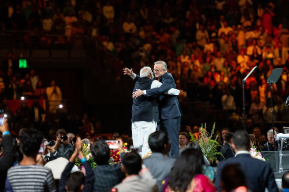 Modi and Albanese hug on stage on Tuesday evening. 