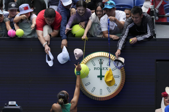 China’s top-ranked women’s tennis player Zheng Qinwen signs autographs for fans after defeating her compatriot Wang Yafan.