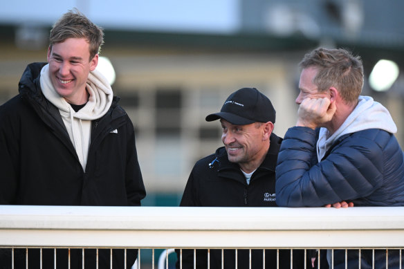 Melbourne Cup winning trainer Chris Waller (centre), who prepares Soulcombe, chats with part-owners, Richmond stars, Tom Lynch and Jack Riewoldt.