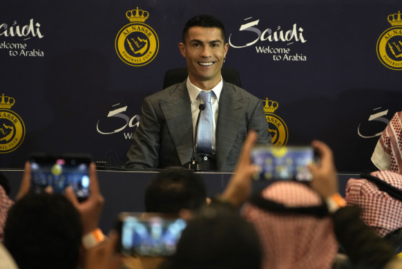 Cristiano Ronaldo smiles during a press conference for his official unveiling as a new member of Al Nassr soccer club in in Riyadh.