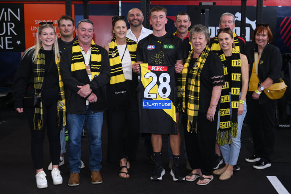 Kane McAuliffe poses with family after presented with first match guernsey. 