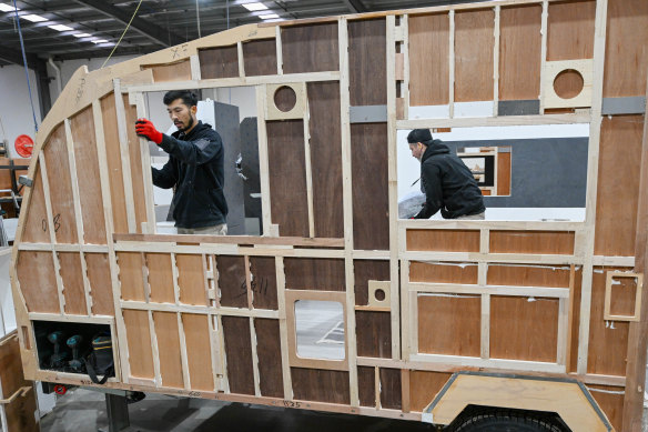 Workers assemble a caravan by hand inside one of about 100 caravan manufacturing businesses in Melbourne’s northern suburbs.