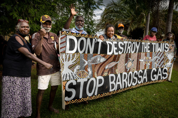 Tiwi Islanders holding a banner they made to protest the Barossa gas project.
