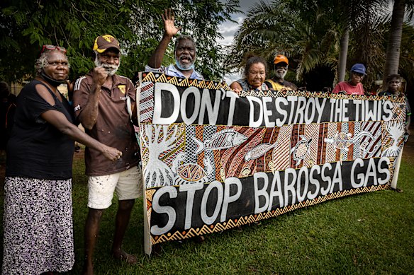 Tiwi Islanders holding a banner they made to protest the Barossa gas project.