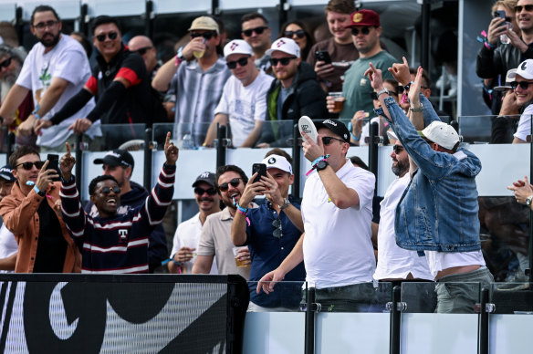 A fan has a shoey at the watering hole during LIV Golf Adelaide.