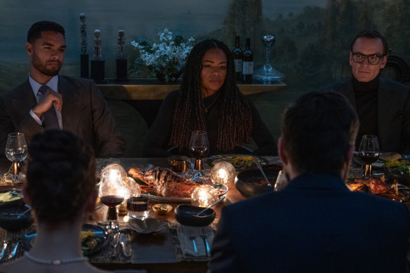 From left: Regé-Jean Page, Naomie Harris and Michael Fassbender share an uneasy dinner in Black Bag.