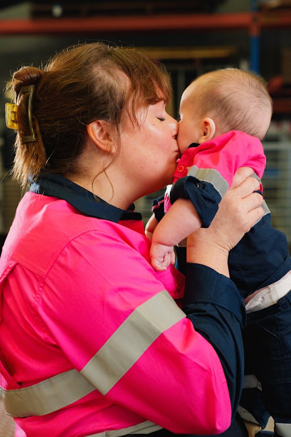 Watkins at work with one of her two children.