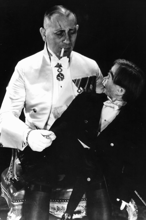 Erich von Stroheim holding the wooden dummy in a scene from the 1929 film The Great Gabbo.