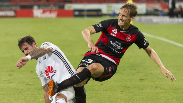 Old hand: Michael Thwaite clears for the Wanderers under pressure from Thomas Doyle of the Phoenix.