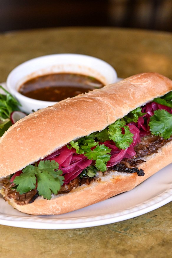 Perfect pub food: brisket torta with birria broth for dipping.