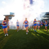 The Bulldogs run onto the field for their round one match against the Demons.