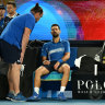 Novak Djokovic talks to a physiotherapist during his match with Carlos Alcaraz.
