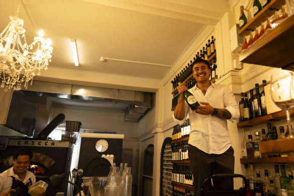 Giles Gabutina (left) smiles as Alessio Nogarotto grabs a bottle.