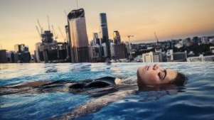 Ava Penklis enjoys the rooftop pool at the Emporium Hotel overlooking the Brisbane CBD.