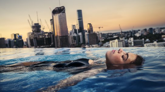 Ava Penklis enjoys the rooftop pool at the Emporium Hotel overlooking the Brisbane CBD.