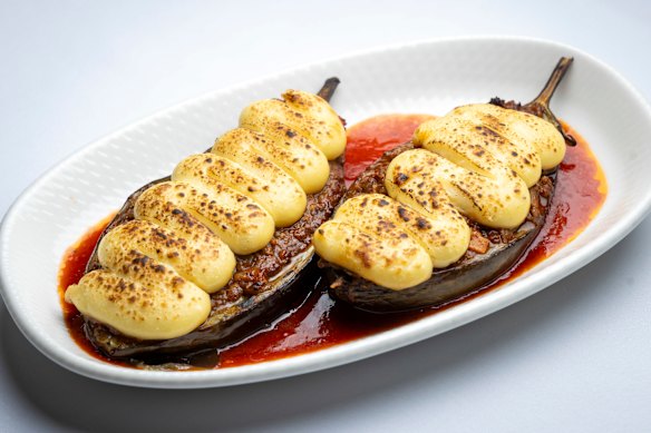 Papoutsakia - eggplant halves covered in rich ragu and fluffy bechamel.