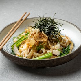 Spanner crab noodles are boosted by shredded nori and bonito flakes.