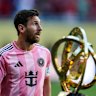 Lionel Messi and the FIFA Club World Cup trophy.