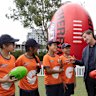 AFL CEO Andrew Dillon speaks to school children as he poses with students from Rosehill Public School during an AFL School Connect visit to Rosehill Public School as part of the build-up to opening round.