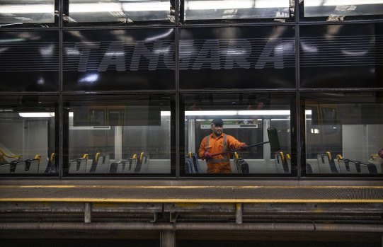 A Sydney trains cleaner on a Tangara at Mortdale Depot. 