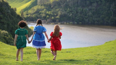 Three young cousins who are separated in the New Zealand film Cousins.