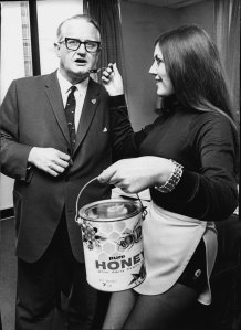 "I can hold the fort in a crisis." Mr Harold Jago, Minister for Health, with Miss Honey Bee (Cheryl Little) circa 1970.
