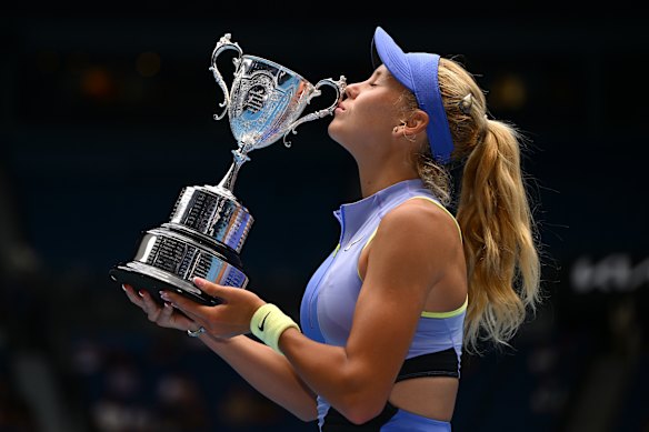Ksenia Efremova of France poses with the championship trophy after winning her junior girls’ singles final.