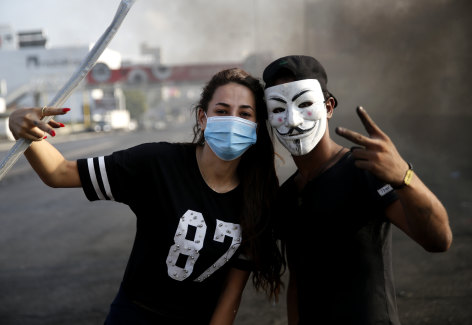 Protesters flash victory signs on Sunday as they block a highway linking Beirut to north Lebanon.