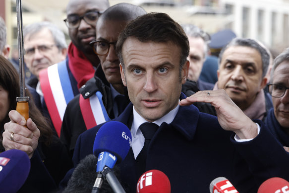 France’s President Emmanuel Macron, surrounded by officials, attends the inauguration ceremony of the Paris 2024 Olympic village in Saint-Denis. 