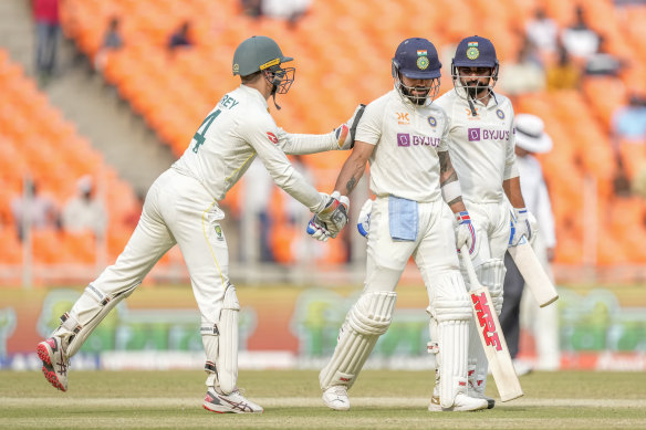 Virat Kohli is congratulated by Alex Carey after his 186.