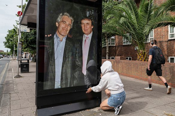 Activists put up a poster showing Donald Trump with Jeffrey Epstein near the US embassy in London.