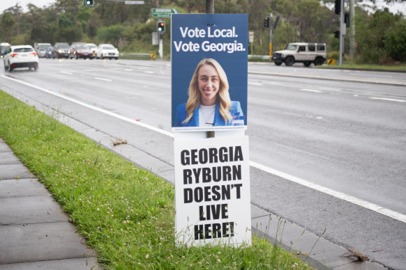 A corflute critical of Georgia Ryburn under her official Liberal Party one on Mona Vale Road.