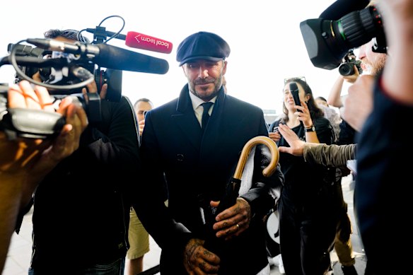 Beckham is surrounded by media after paying his respects to the late Queen Elizabeth II in Westminster Hall in 2022.