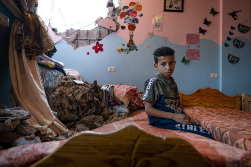 Ten-year-old Ibrahim sits in his bedroom in Beit Hanoun in the Gaza Strip. The room was damaged by an Israeli air strike that destroyed the neighbouring building in May.