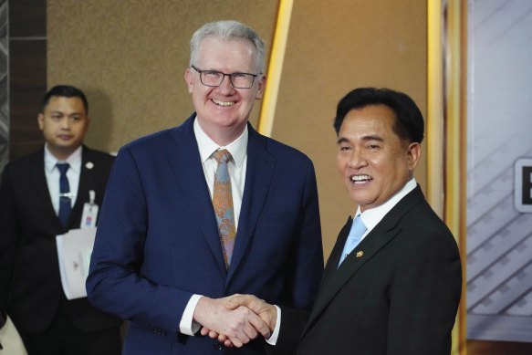Home Affairs Minister Tony Burke, left, shakes hands with Indonesian Coordinating Minister for Legal, Human Rights, Immigration and Correctional Affairs, Yusril Ihza Mahendra.