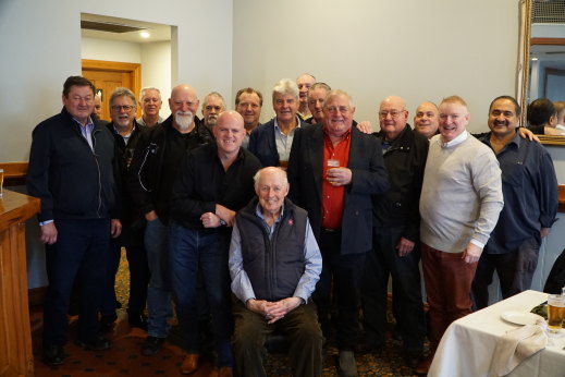 Bryan Harding, seated, surrounded by friends and former colleagues at a celebration at Hogan’s Hotel in Wallan last week. Harding has written a book detailing his time with Victoria Police, including as leader of the police union.  