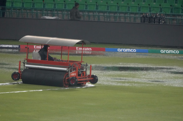 A super sopper attempts to dry out the wet outfield area after rains stops the play.
