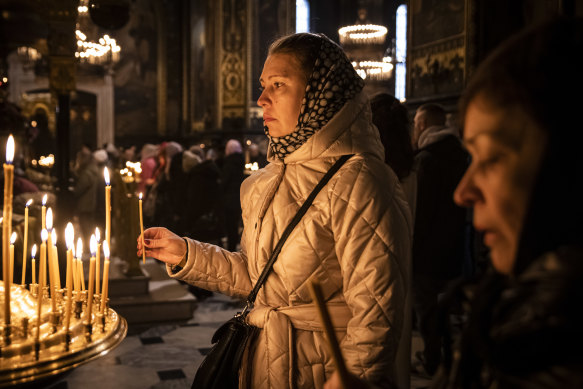 Worshippers at St Volodymyr’s Cathedral in Kyiv. Electricity and heating outages across Ukraine caused by missile and drone strikes to energy infrastructure have added urgency preparations for winter.
