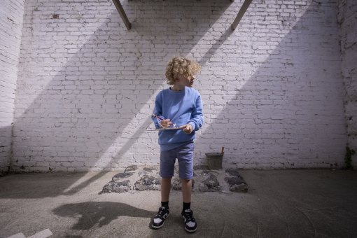 Liam Lees looks for clues in a rock breaking yard during a tour in the former Pentridge Prison.