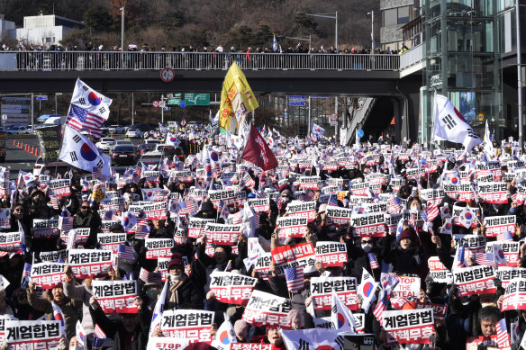 Yoon’s supporters stage a rally on Thursday to oppose the president’s potential arrest after a court issued a warrant.
