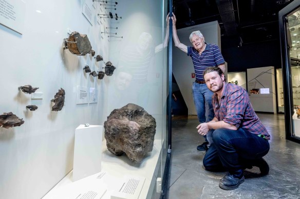 Lindenmayer and Dr Bill Birch with the larger meteorite fragment, that is on display.