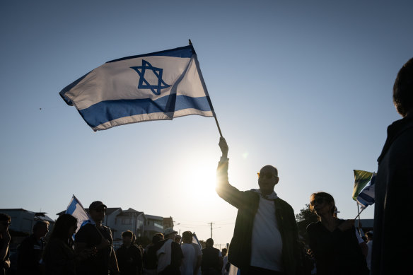 The Israeli flag is flown at a Jewish vigjl at Dover Heights.