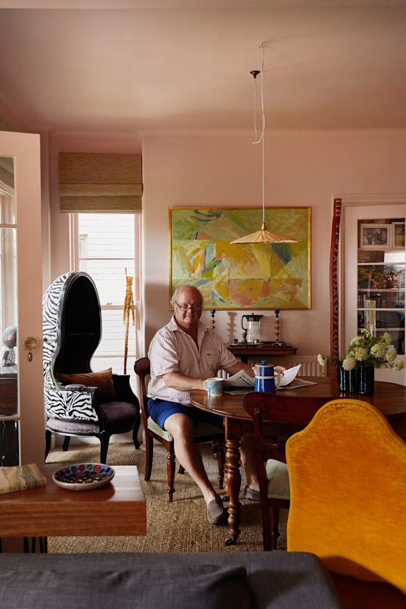 Peter Frith in his dining room, surrounded by eclectic objects. The willow pendant light is by Annemarie O’Sullivan of Studio Amos. The painting is by Alan Warren.