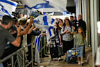 Israeli passengers are welcomed at the arrivals gate at Ben Gurion International Airport.