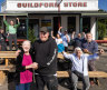 Happy result: Norma and Curtis Hancock with Save Our Store campaigners including Christine Mierisch, seated, front right, and Liz Monty, standing left, in green.