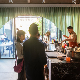 Cocktails and bar snacks on a city rooftop in Melbourne.